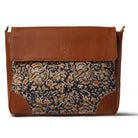 Brown leather bag with floral pattern on a white background