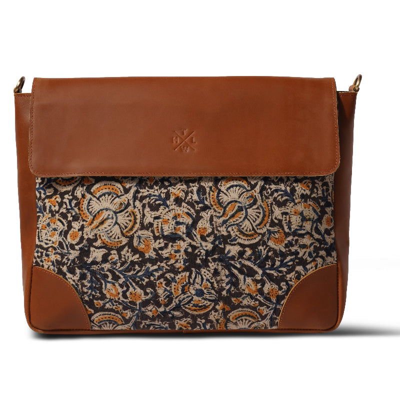 Brown leather bag with floral pattern on a white background