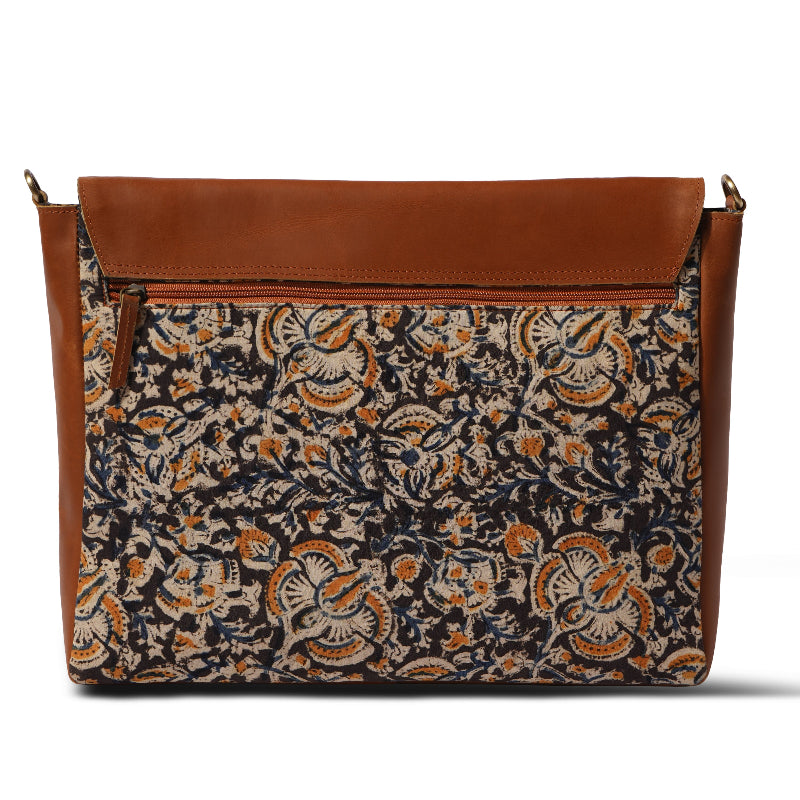 Floral patterned bag with brown leather accents on a white background