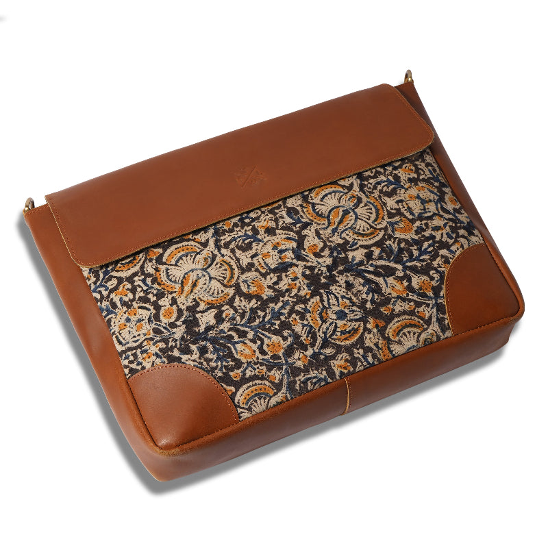Brown leather clutch with floral pattern on a white background