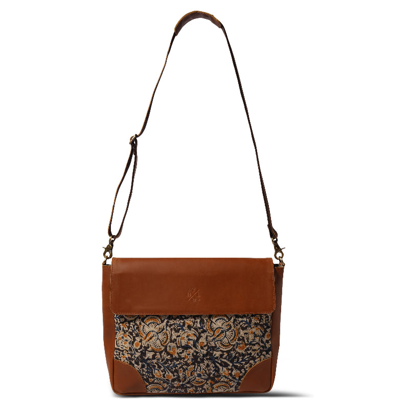 Brown leather bag with floral pattern on a white background
