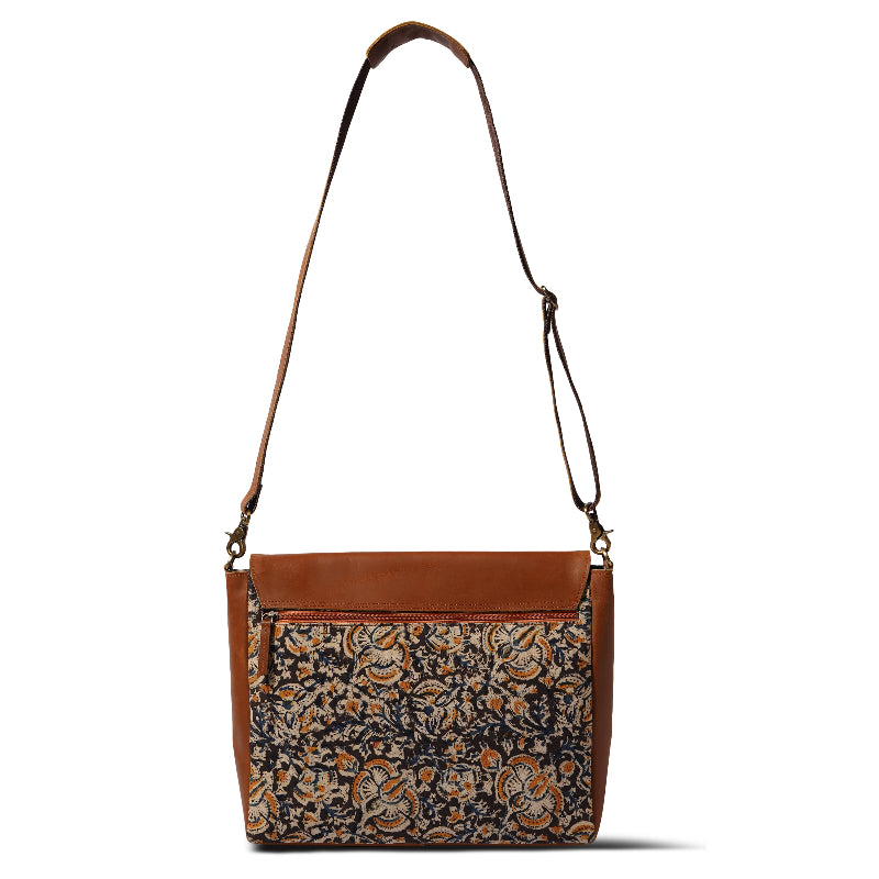 Patterned handbag with brown leather accents on a white background