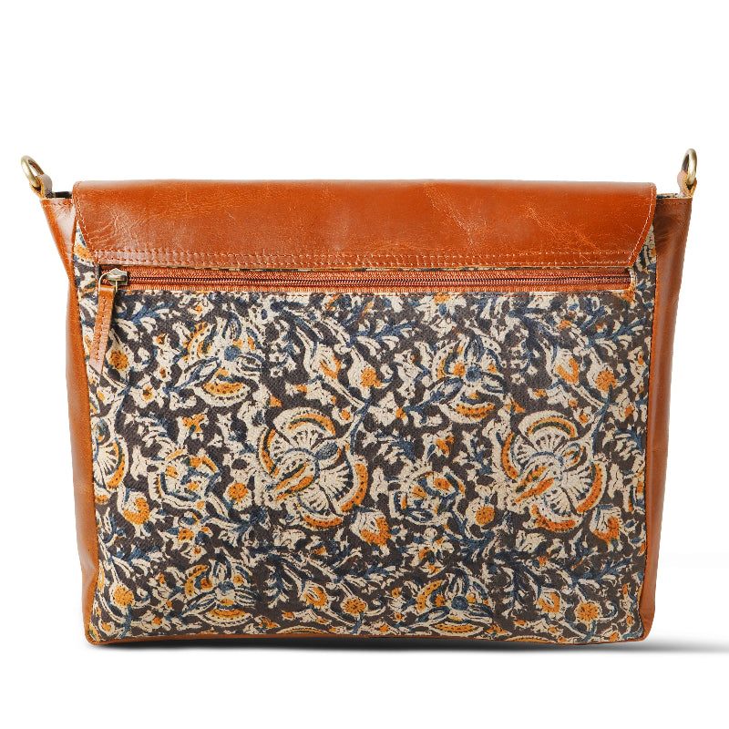 Handbag with floral pattern and brown leather accents on a white background