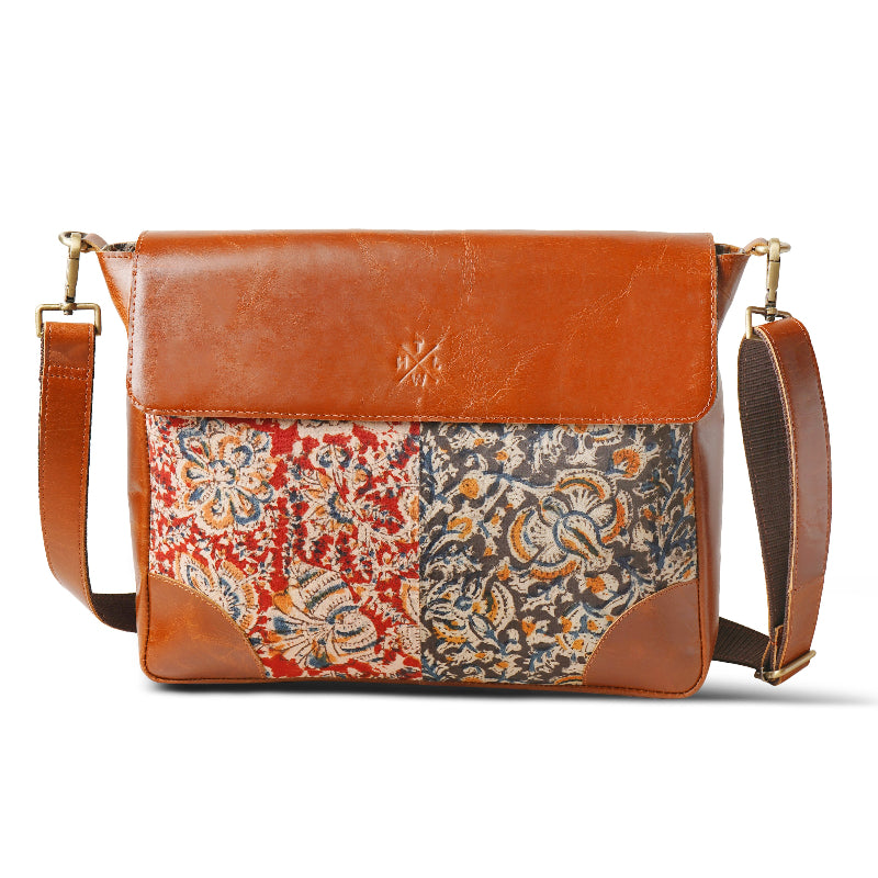 Brown leather crossbody bag with patchwork floral pattern on a white background
