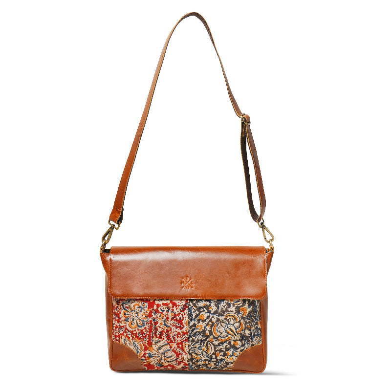 Brown leather handbag with floral pattern on a white background