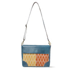 Blue crossbody bag with a colorful zigzag pattern on a white background