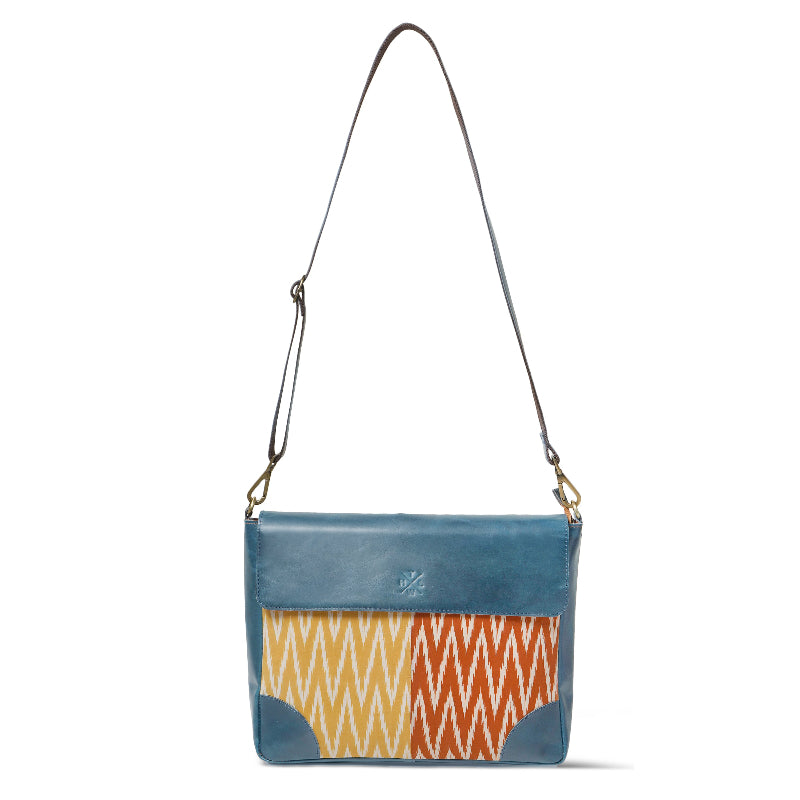 Blue crossbody bag with a colorful zigzag pattern on a white background
