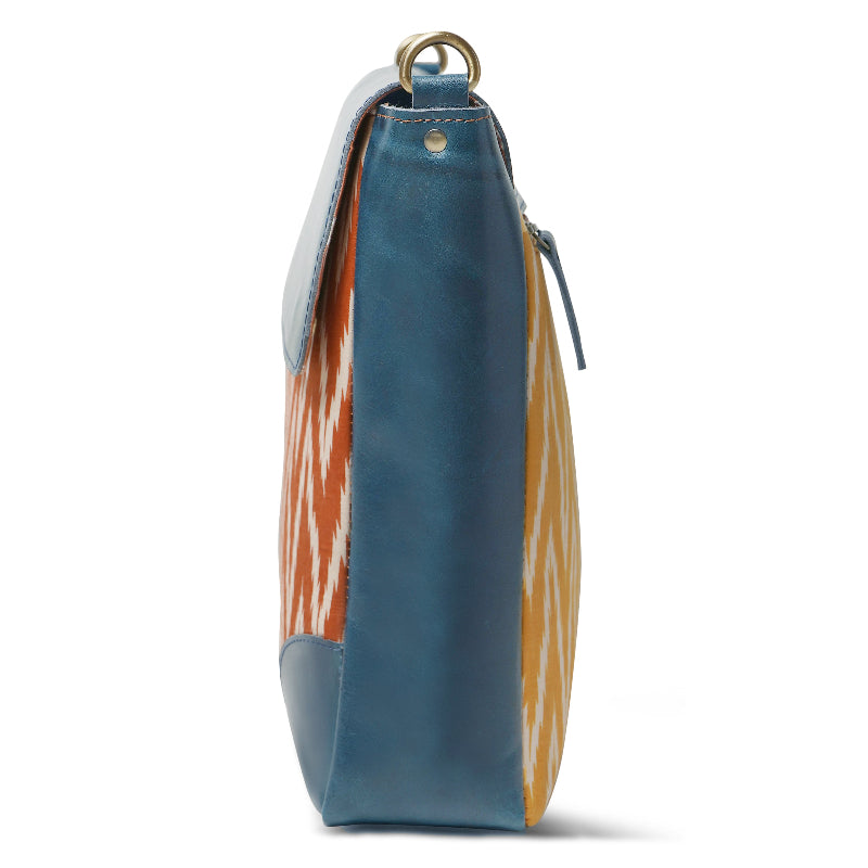Blue handbag with orange and white pattern on a white background