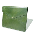 Green leather clutch bag on a white background