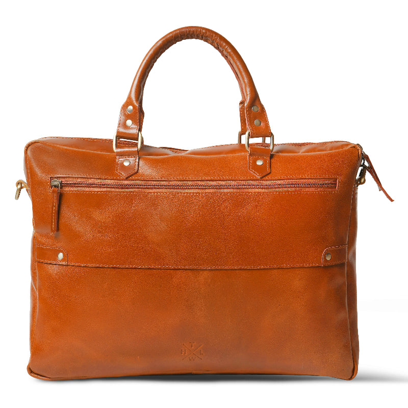 Brown leather bag with gold accents on a white background