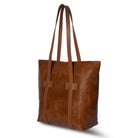 Brown leather tote bag on a white background