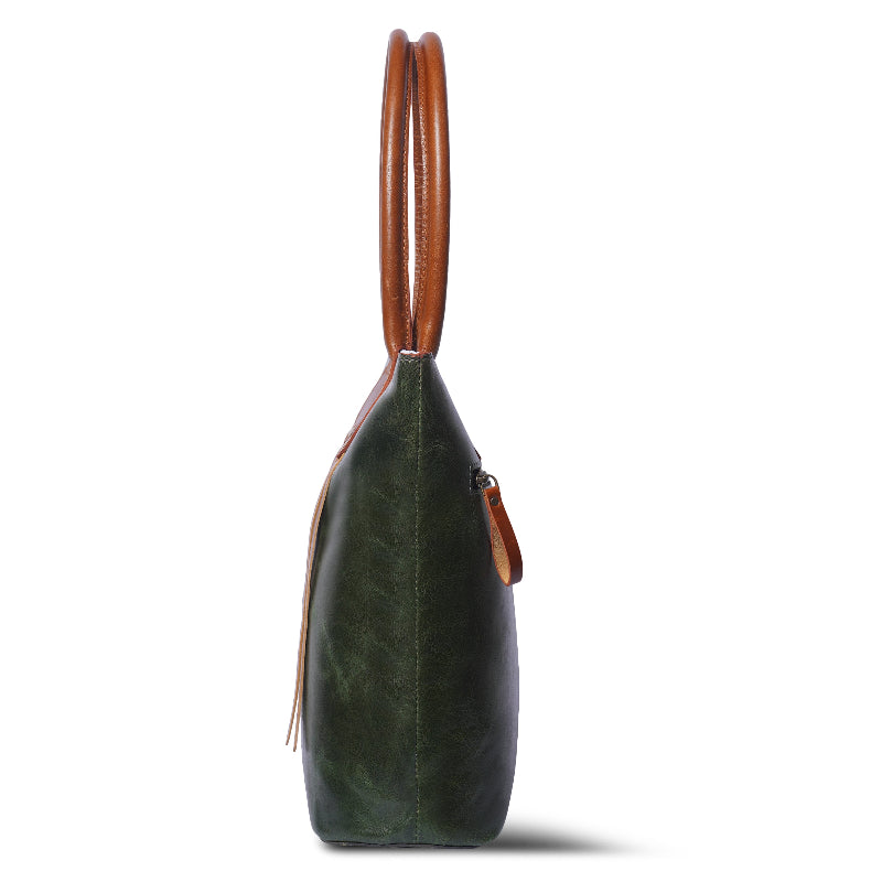 Green leather handbag with brown handle on a white background