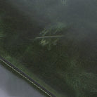 Close-up of a textured green surface with a brand logo.