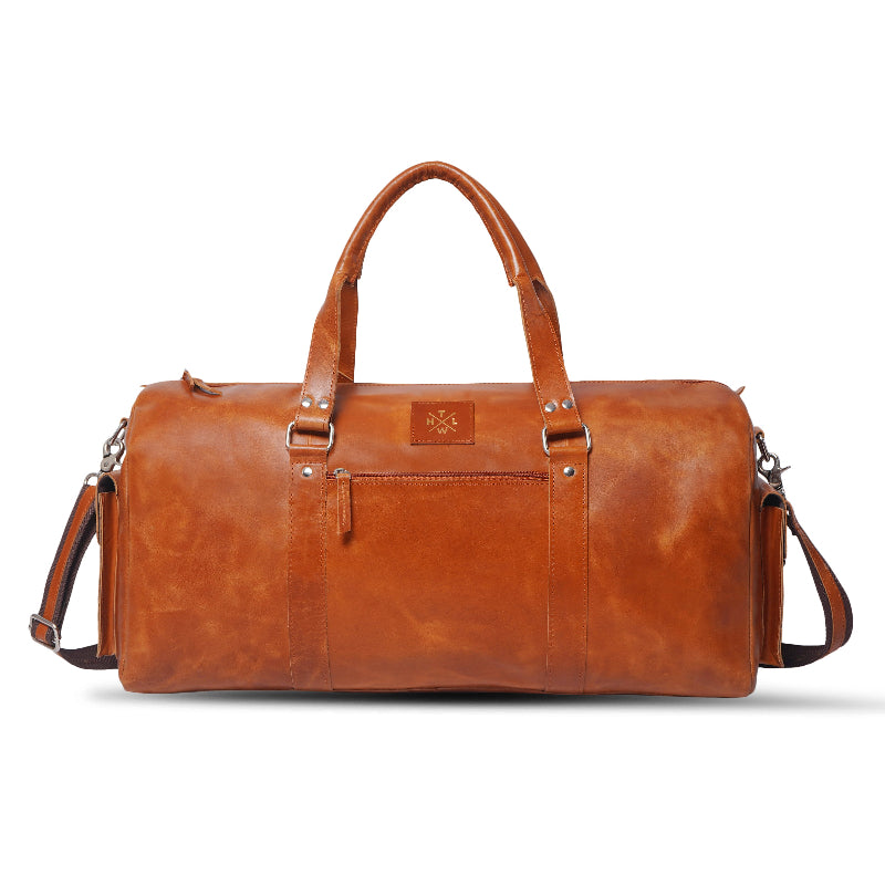 Brown leather travel duffle bag with handles and shoulder strap, premium handcrafted design