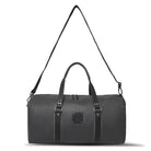 Black duffel bag with straps on a white background