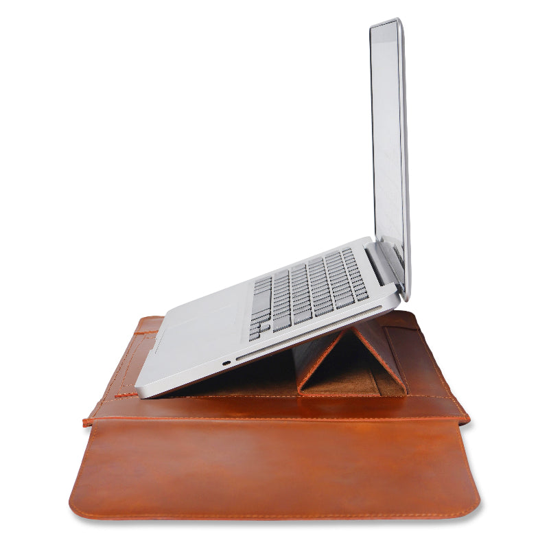Laptop on a brown leather stand sleeve with a white background