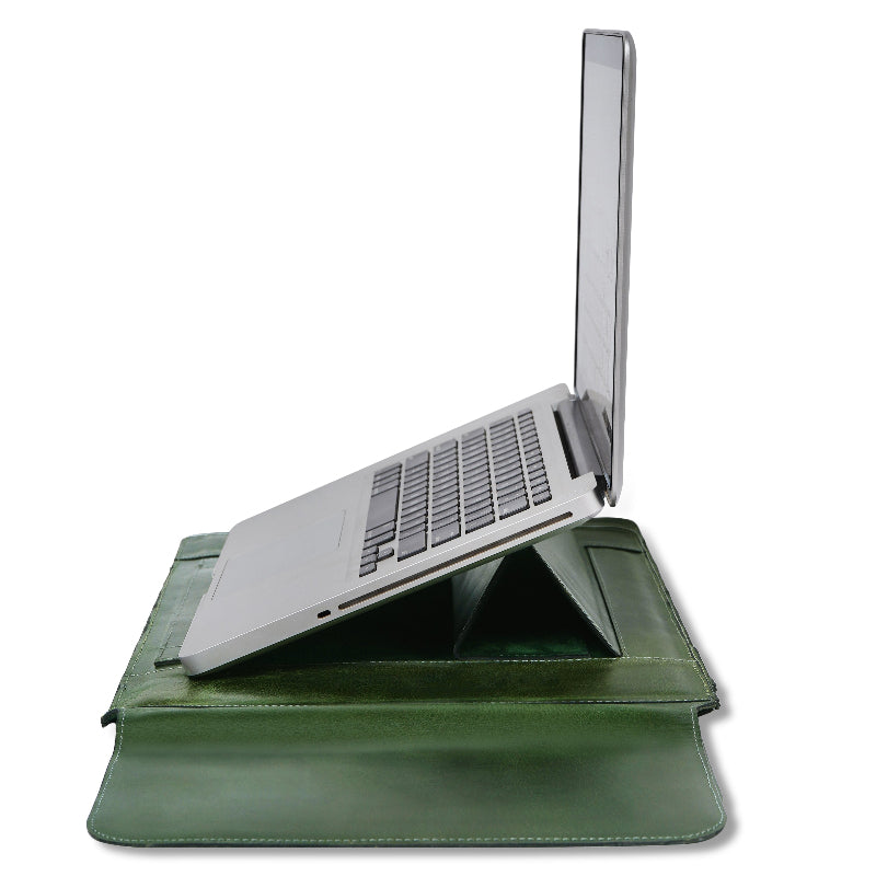 Green leather laptop sleeve with built-in stand holding an open silver laptop at an ergonomic angle on a white background