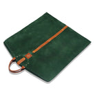 Green hanging bag  with brown leather accents on a white background