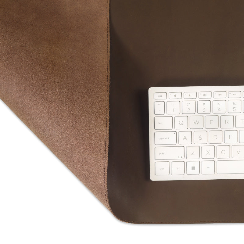 White keyboard on a brown leather surface