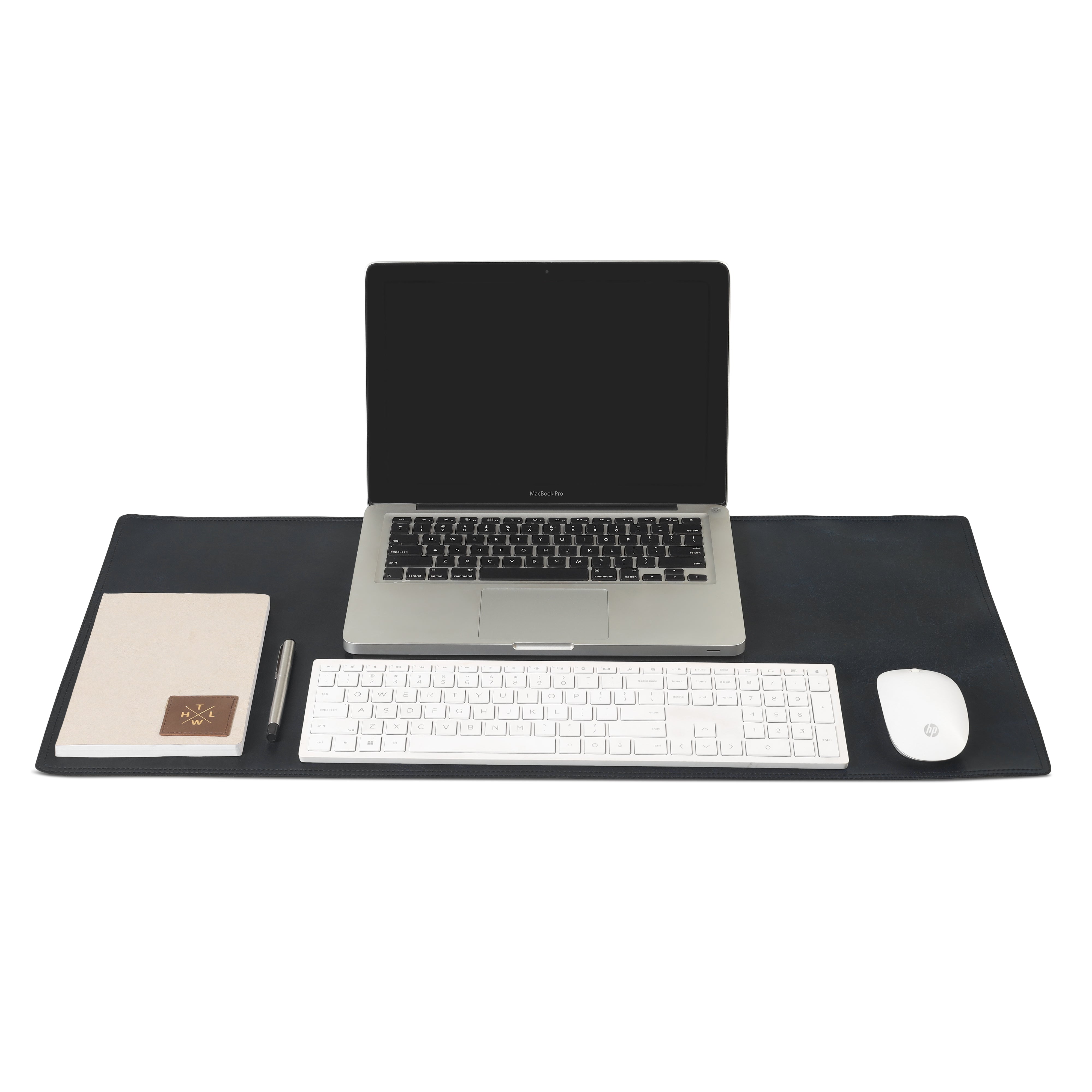 Black leather desk mat with a laptop, wireless keyboard, mouse, notebook, and pen neatly arranged on top.