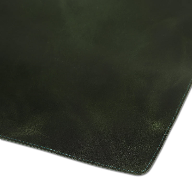 Dark green leather desk mat on a white background