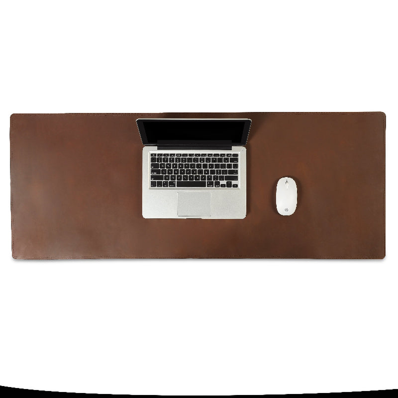 Brown leather desk pad with a laptop and mouse on a white background