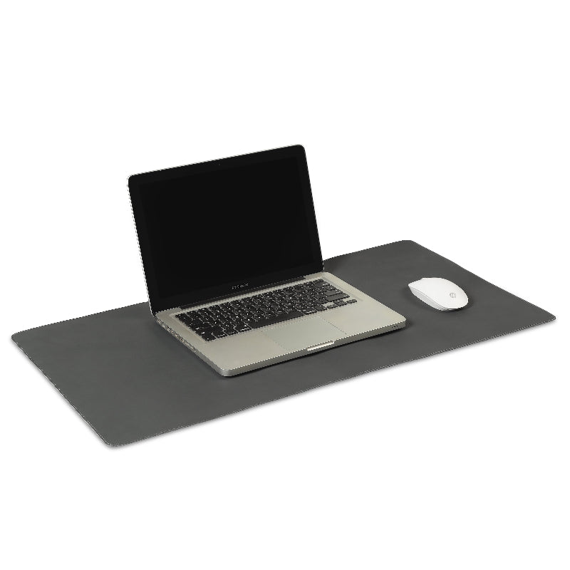 Laptop and mouse on a large black desk pad with a white background
