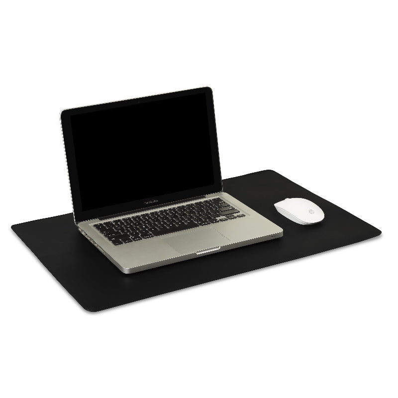 Laptop on a black desk pad with a mouse to the right, on a white background