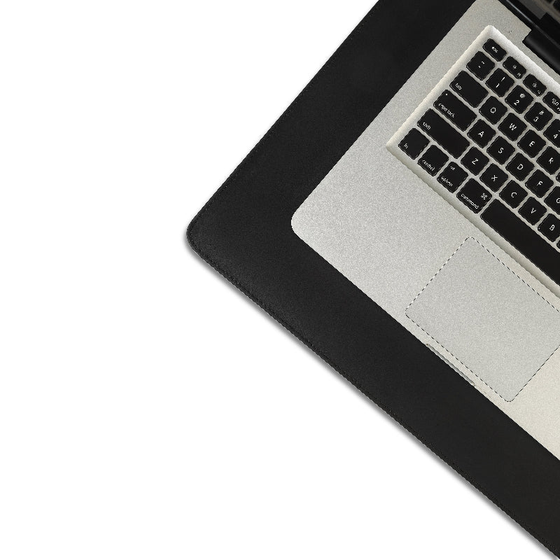 Laptop on a black desk with a white background