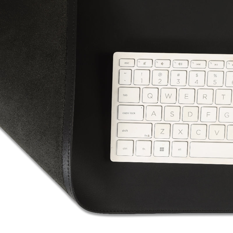 Black keyboard cover with a white keyboard on a black desk mat