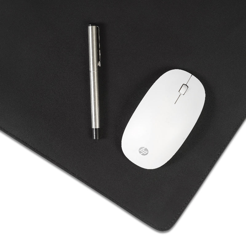 White mouse and pen on a black mouse pad