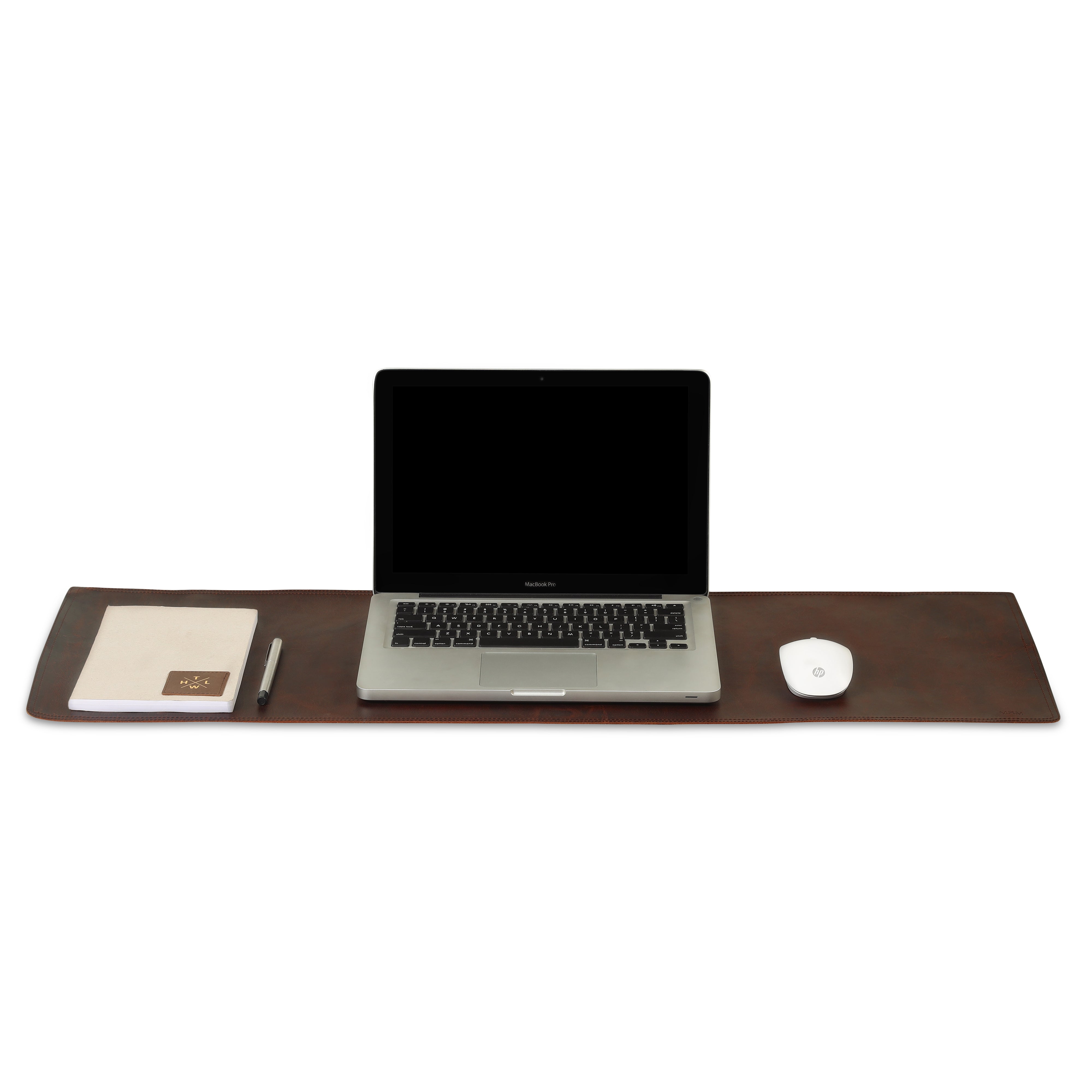 Brown leather desk mat with a laptop notebook pen and wireless mouse neatly arranged on top.