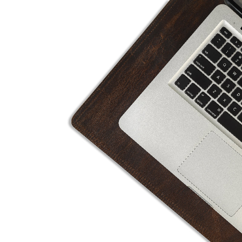 Laptop on a wooden desk with a white background
