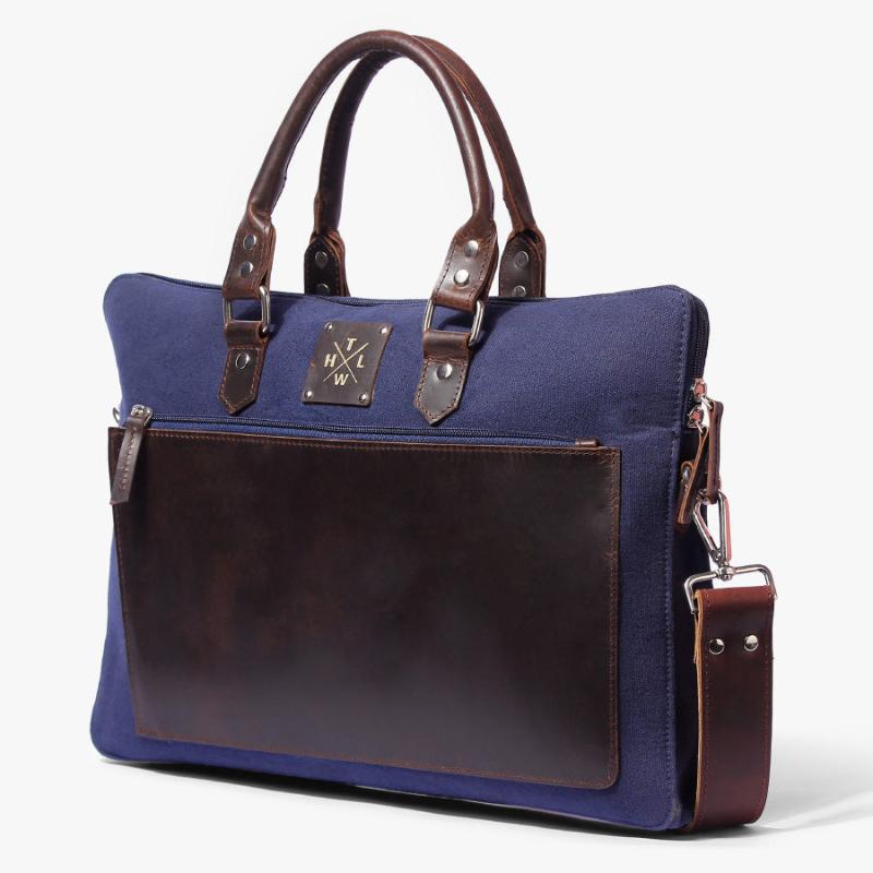 Blue canvas and brown leather laptop bag with sturdy handles and shoulder strap
