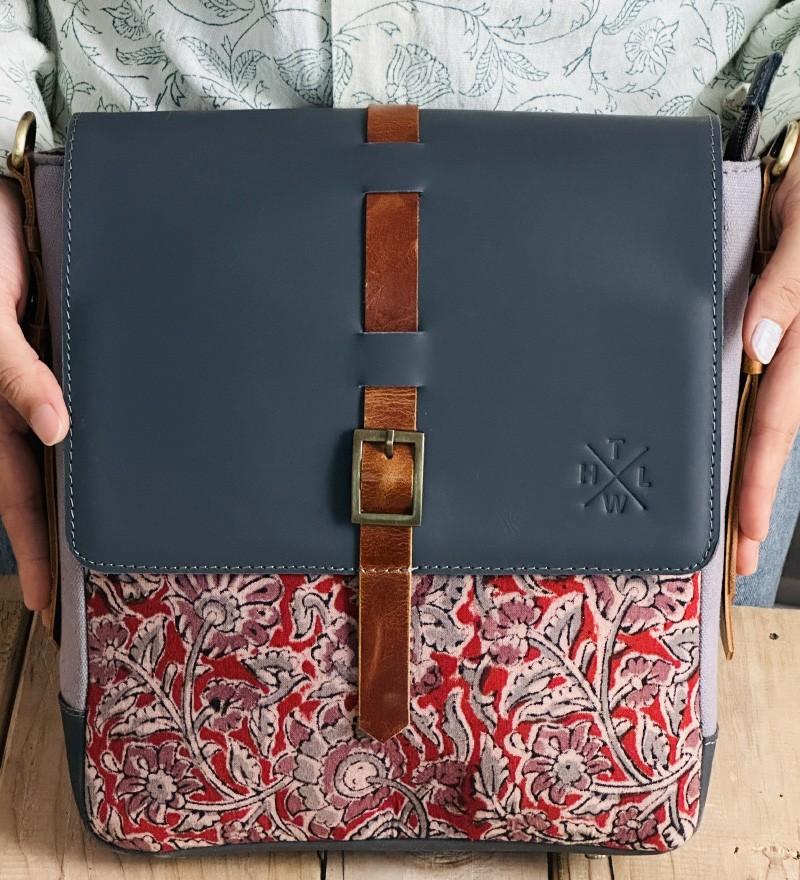 Premium leather crossbody bag with floral fabric detailing and adjustable strap