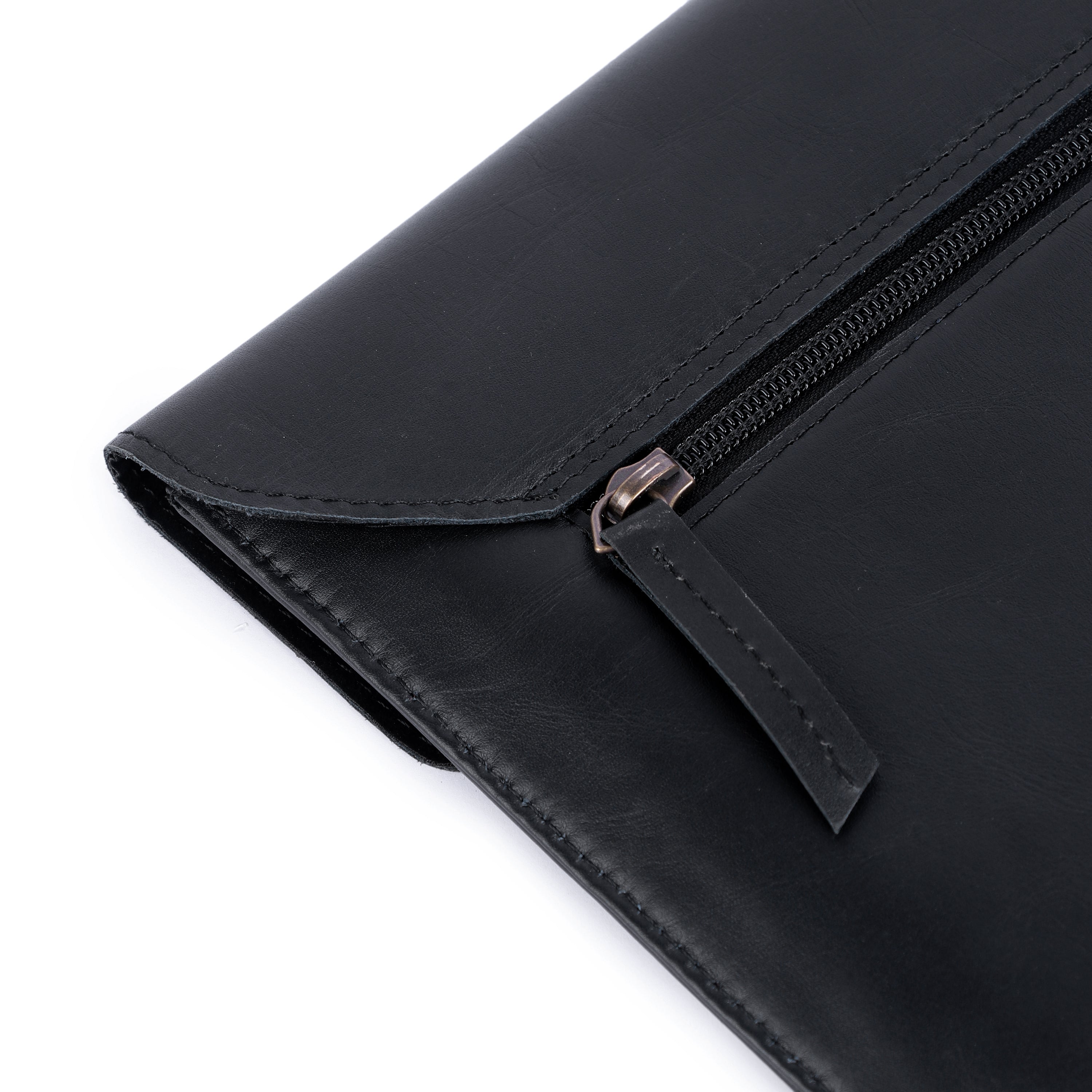 Black leather clutch with zipper on a white background