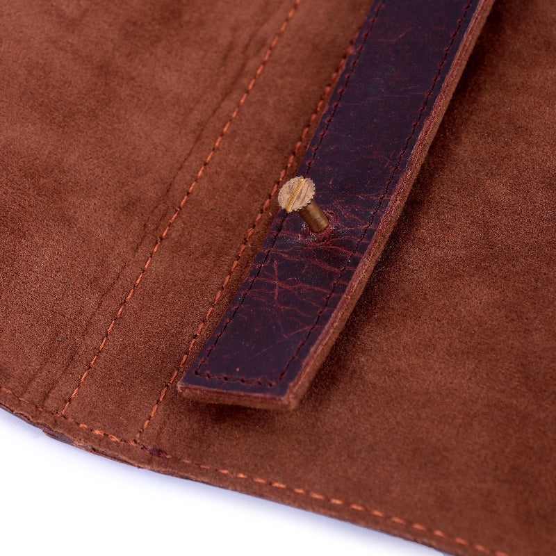 Close-up of brown leather material with stitching detail on a white background
