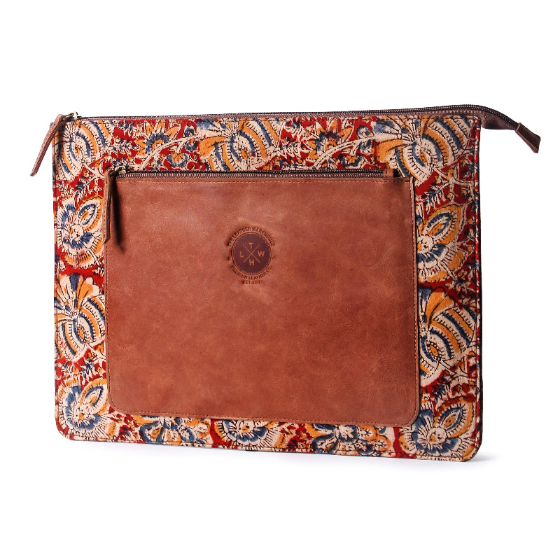 Handcrafted leather laptop sleeve with a brown leather front pocket and a colorful floral-patterned fabric border, featuring The Leather Warehouse (TLWH) logo embossed on the leather.