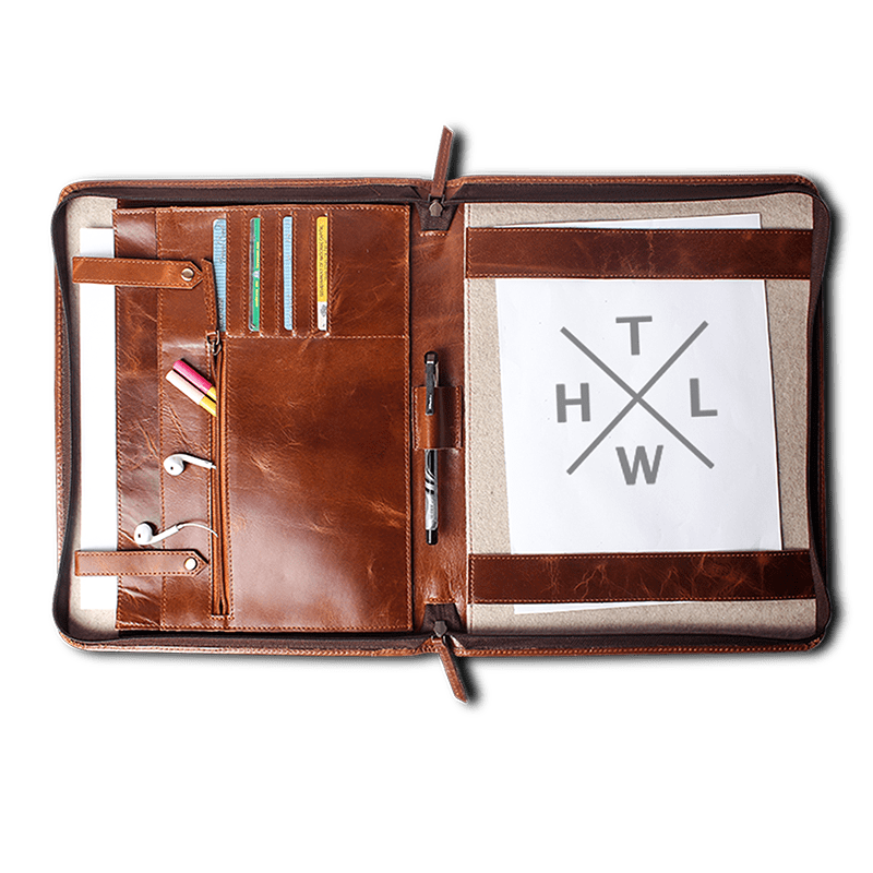 Brown leather file folder open with laptop pocket compartments and office supplies neatly arranged