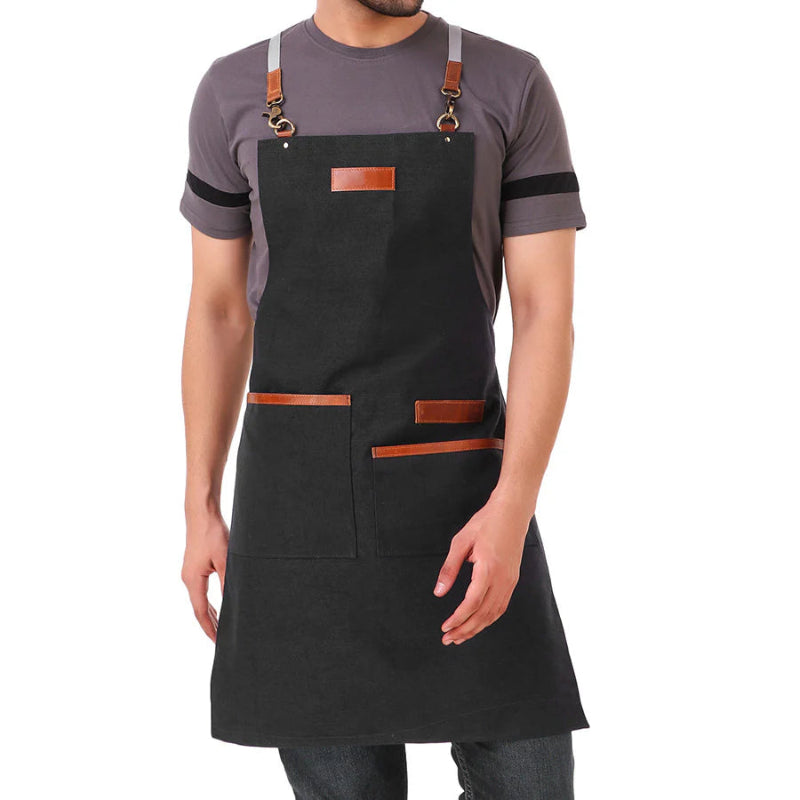 Person wearing a black apron with brown leather accents on a white background
