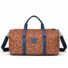 Patterned duffel bag with blue straps on a white background