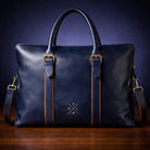 Blue leather bag with gold accents on a dark background