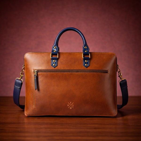 Brown leather briefcase with blue handles and strap on a wooden surface and brown background