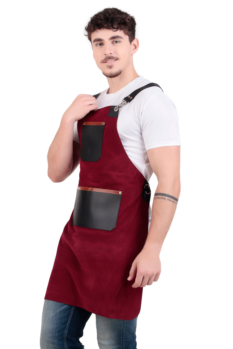 Man wearing a maroon apron with black pockets on a white background