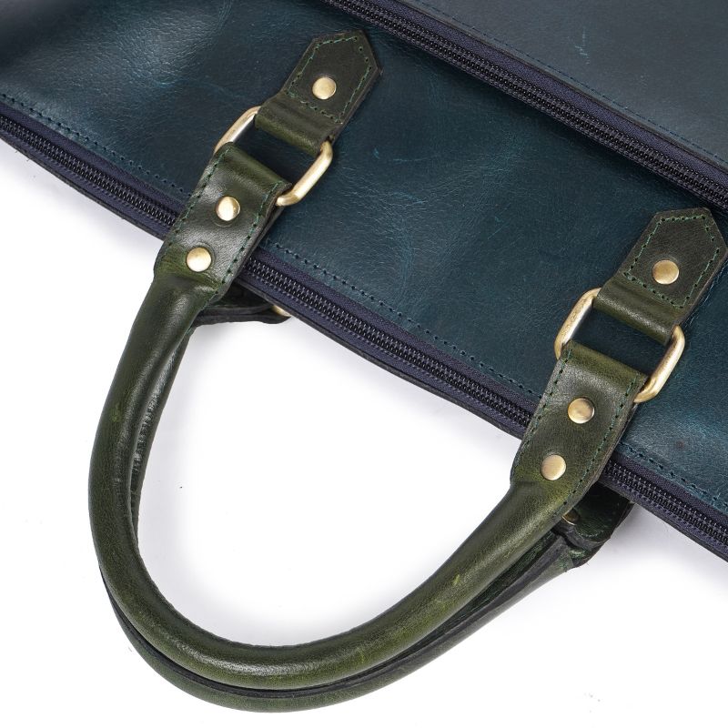 Close-up of leather bag handles and metal fittings.