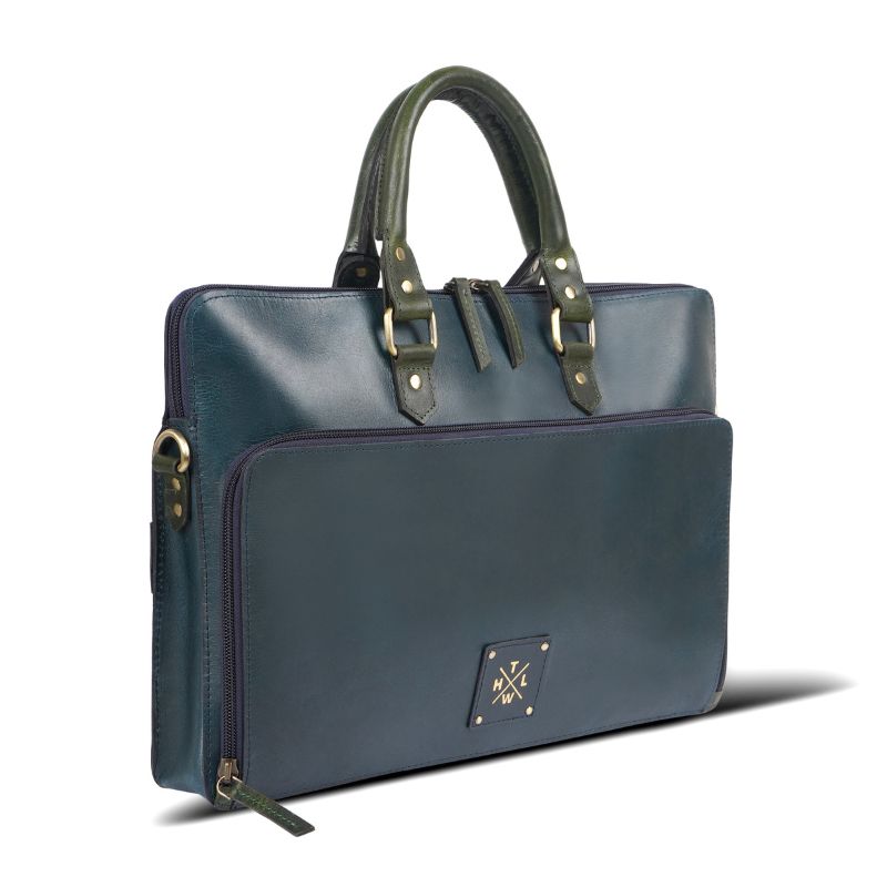 Side angle of navy blue leather handbag.