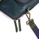 Close-up of zipper pulls and shoulder strap attachment.