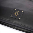 Black leather clutch with gold logo on a white background