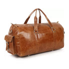 Brown leather duffel bag on a white background