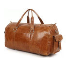 Brown leather duffel bag on a white background